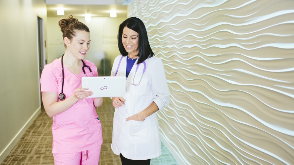 QC Health in healthcare a female nurse and doctor using QC Health on a Microsoft Surface